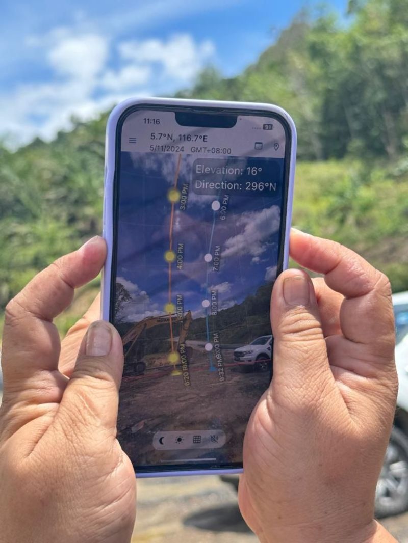 Hands holding phone displaying a navigation app